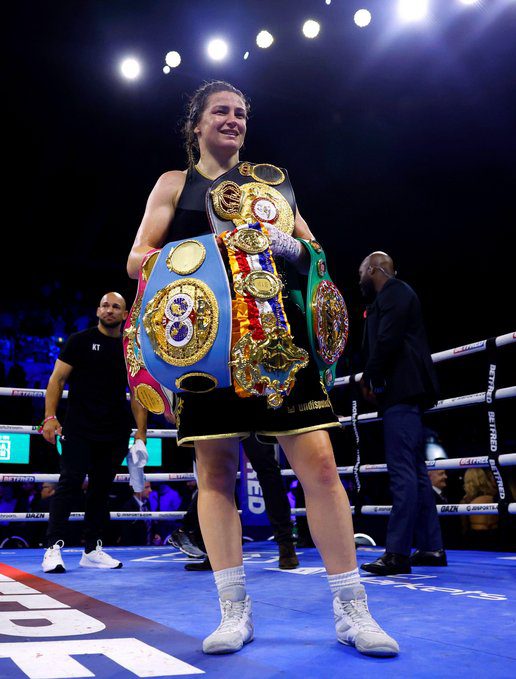 Katie Taylor celebrates with her boxing belts
